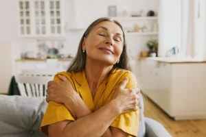 Happy lady hugging herself